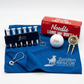 Golf accessories including tees, towel, ball, and keychain on a white background